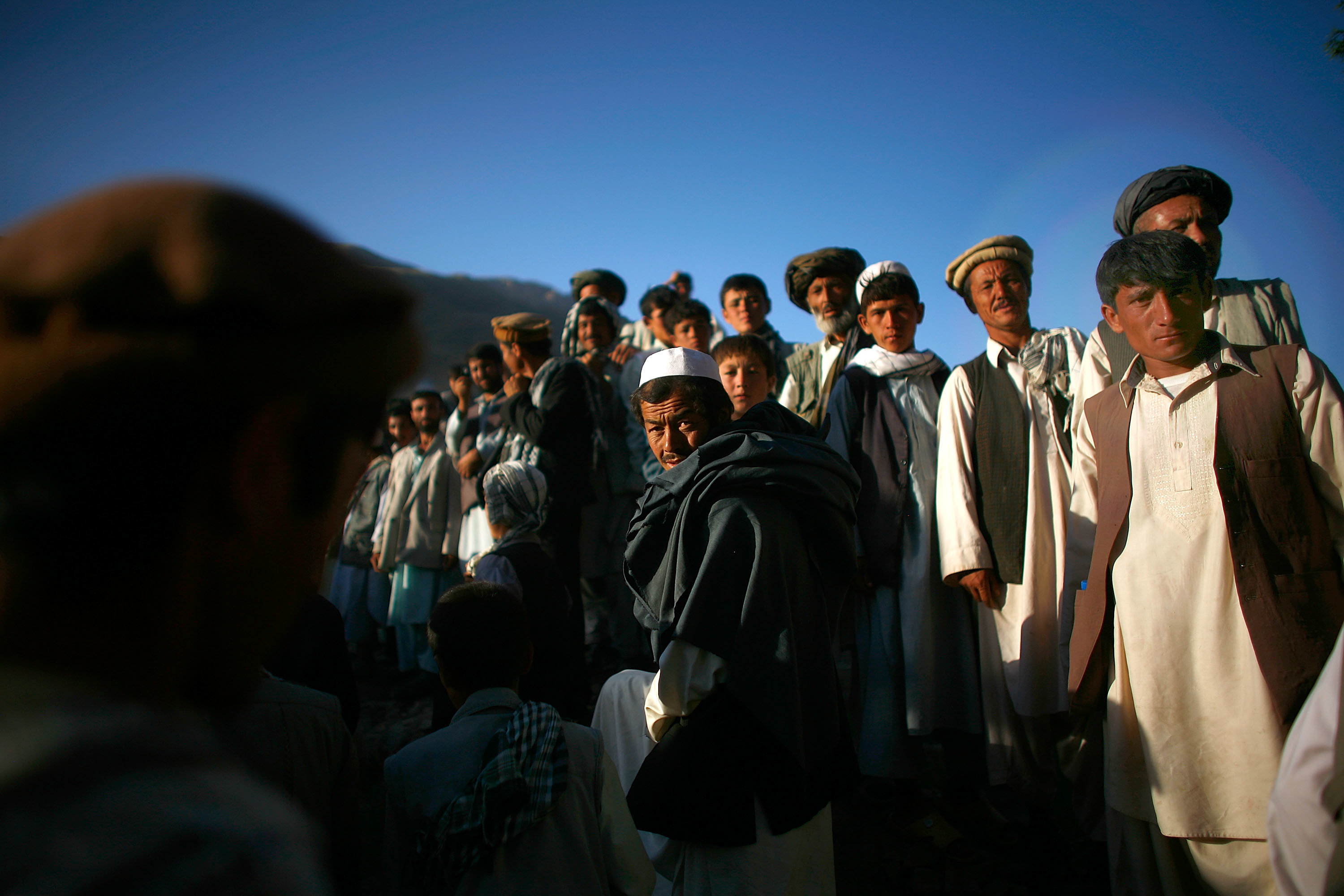 An Artist And A Warrior: Colleague Remembers Fallen NPR Photographer David Gilkey 15 Afghan men assemble for a campaign visit from President Hamid Karzai.