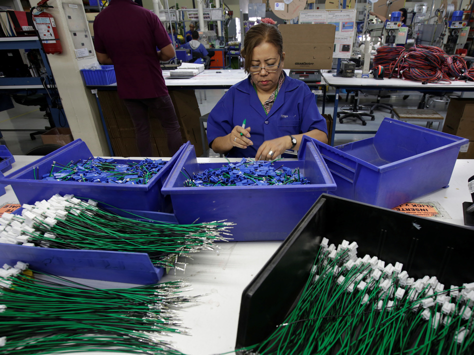 An employee works at a wiring harness and cable assembly manufacturing company in Ciudad Juárez, Mexico, that exports to the U.S. in 2017. The auto industry says threatened tariffs would play havoc with supply chains. (Jose Luis Gonzalez/Reuters)