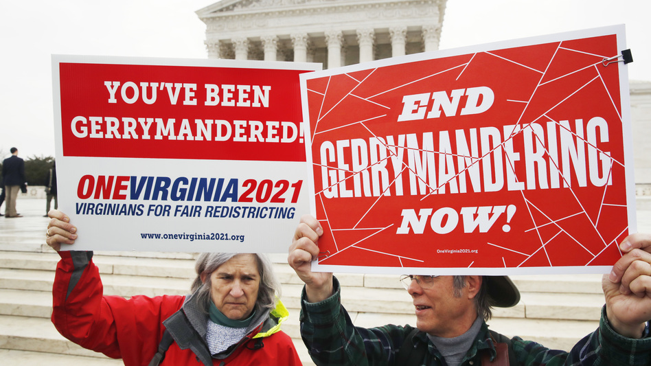 Sara Fitzgerald and Michael Martin, both with the group One Virginia, protest gerrymandering in front of the Supreme Court in March 2018. (Jacquelyn Martin/AP)