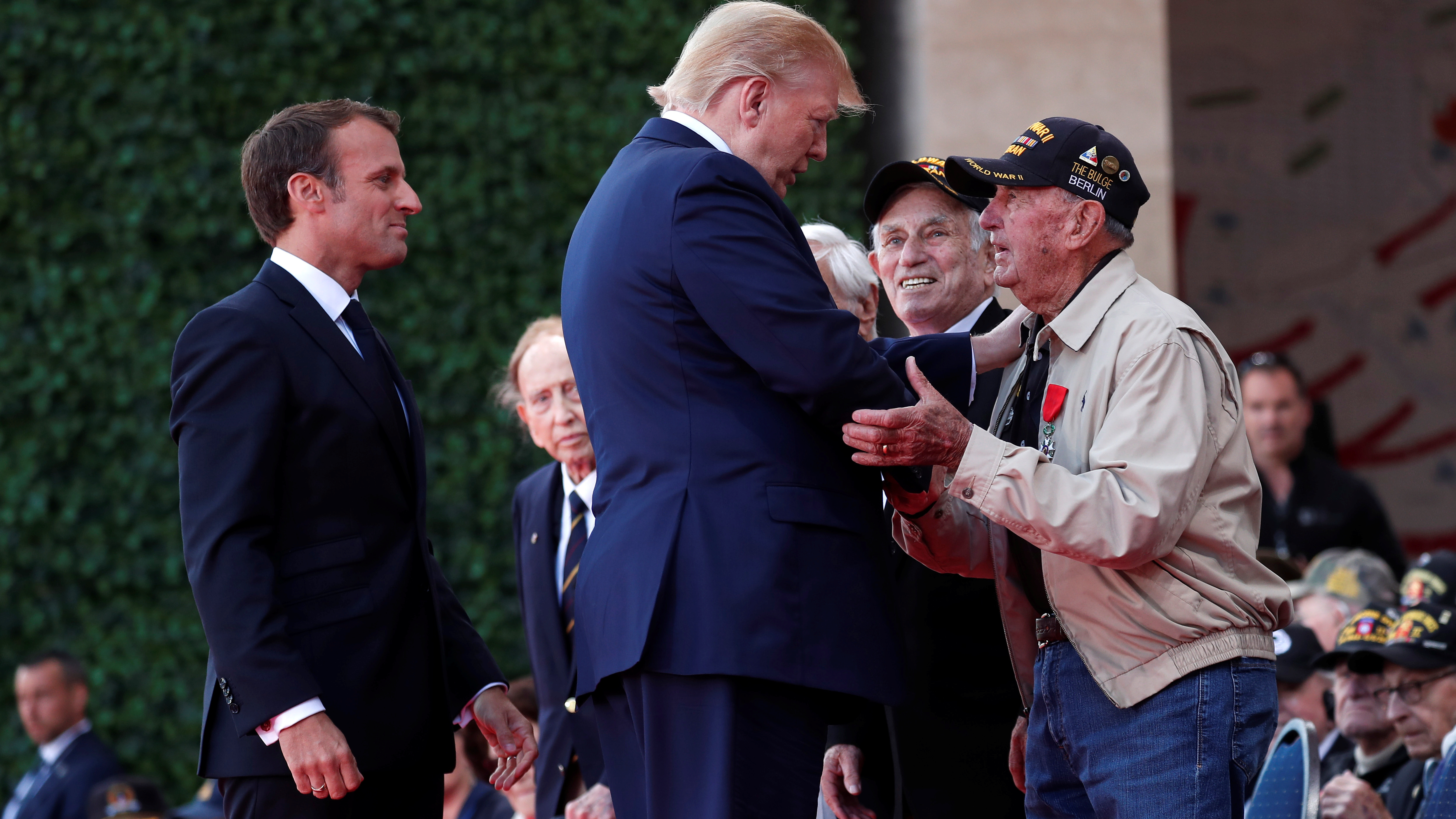 President Trump and French President Emmanuel Macron greet a U.S. veteran during the D-Day commemoration at the Normandy American Cemetery and Memorial in Colleville-sur-Mer, France. (Reuters)