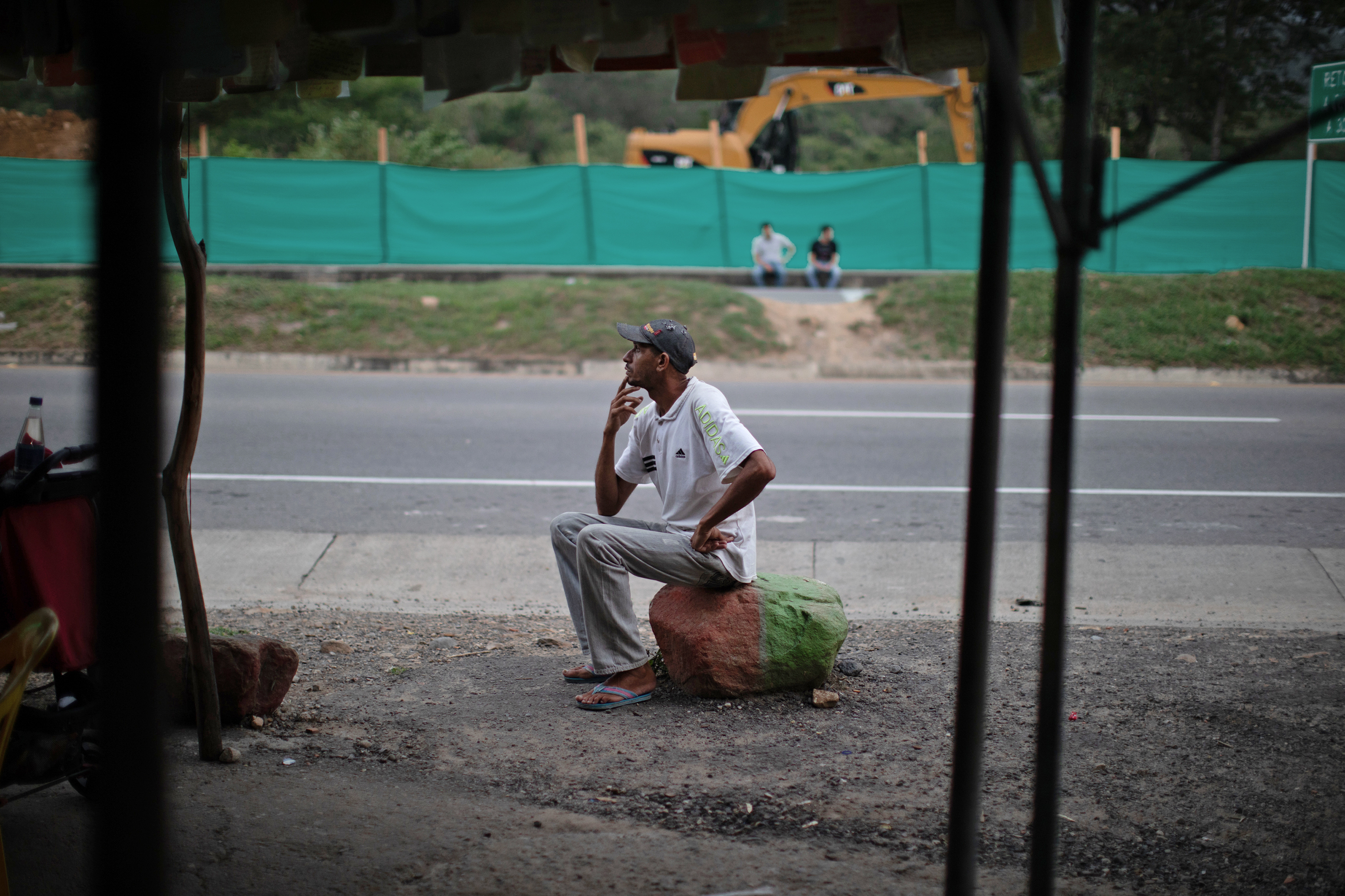 Oscar Martínez, one of more than four million Venezuelans who have left their country, rests at a roadside stand near Cucuta, Colombia. (NPR)