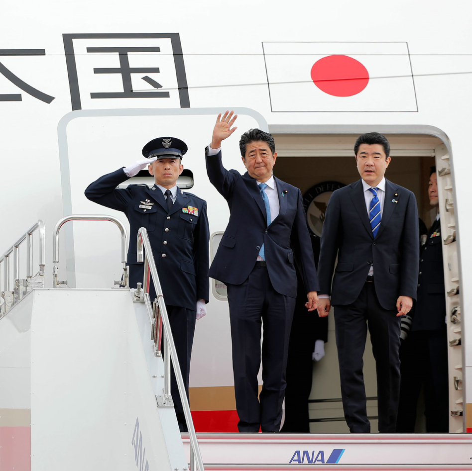 Japan's Prime Minister Shinzo Abe waves to well-wishers on his departure from Tokyo's Haneda Airport on Wednesday for a two-day visit to Iran. (Jiji Press/AFP/Getty Images)