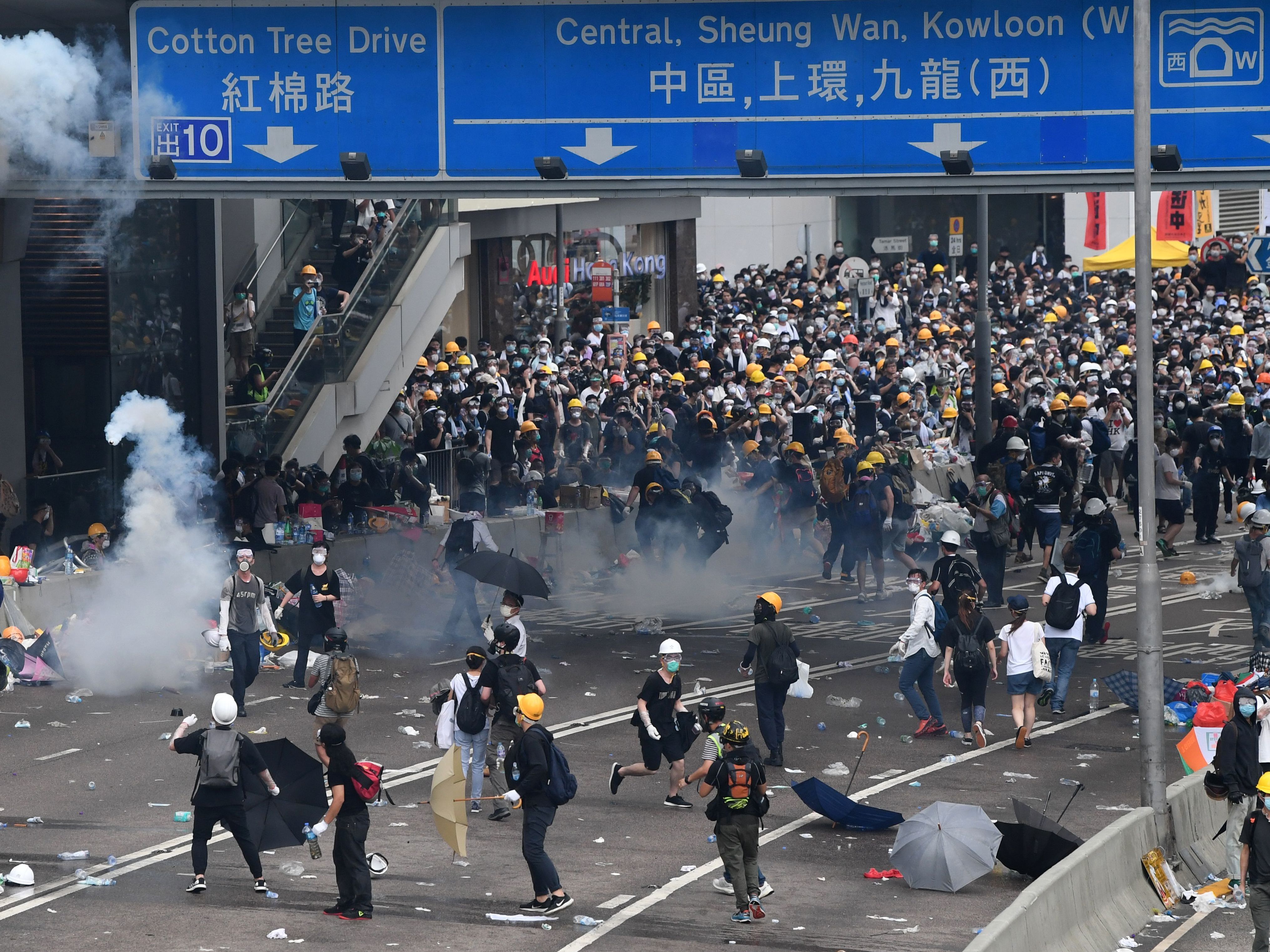 Protesters react after police fired tear gas during a rally against a controversial extradition law proposal outside the government headquarters in Hong Kong on Wednesday. (AFP/Getty Images)