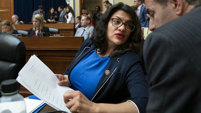 Rep. Rashida Tlaib, D-Mich., pauses as the House Oversight and Reform Committee votes on Wednesday to hold Attorney General William Barr and Commerce Secretary Wilbur Ross in contempt for failing to turn over subpoenaed documents related to the Trump administration's decision to add a citizenship question to the 2020 census. (J. Scott Applewhite/AP)