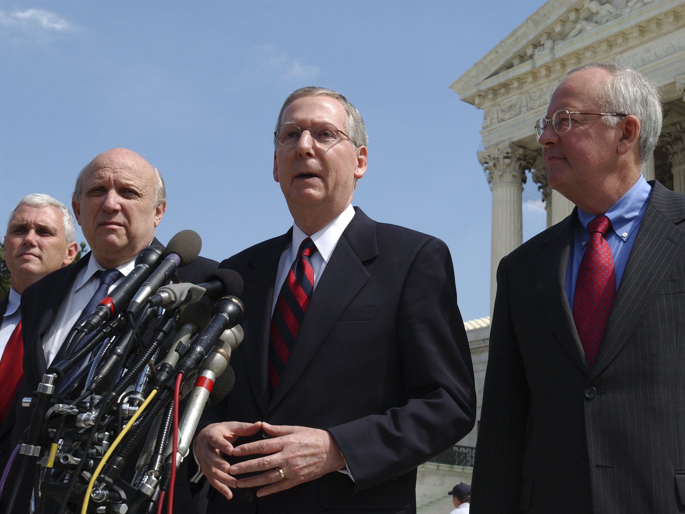 Senator Mitch McConnell stands outside the U.S. Supreme Court with his legal team, who challenged the constitutionality of the McCain-Feingold campaign finance law. (Roll Call via Getty Images)