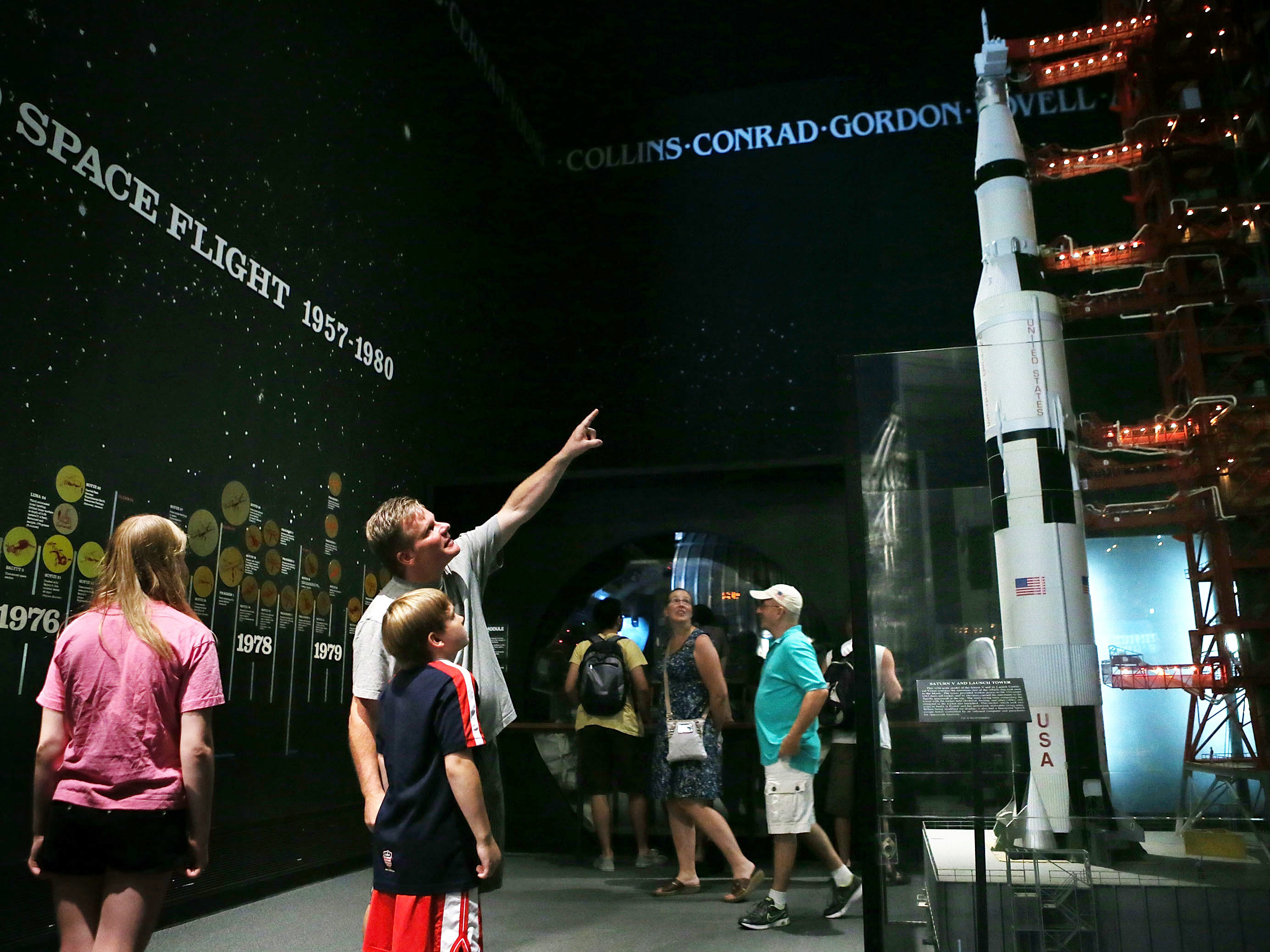 Visitors look at a model of a Saturn V rocket and its launch umbilical tower, which were used during the Apollo moon-landing program, at the Smithsonian National Air and Space Museum in Washington, D.C. Fifty years ago this July 20, Neil Armstrong and Buzz Aldrin became the first humans to walk on the moon. (Getty Images)