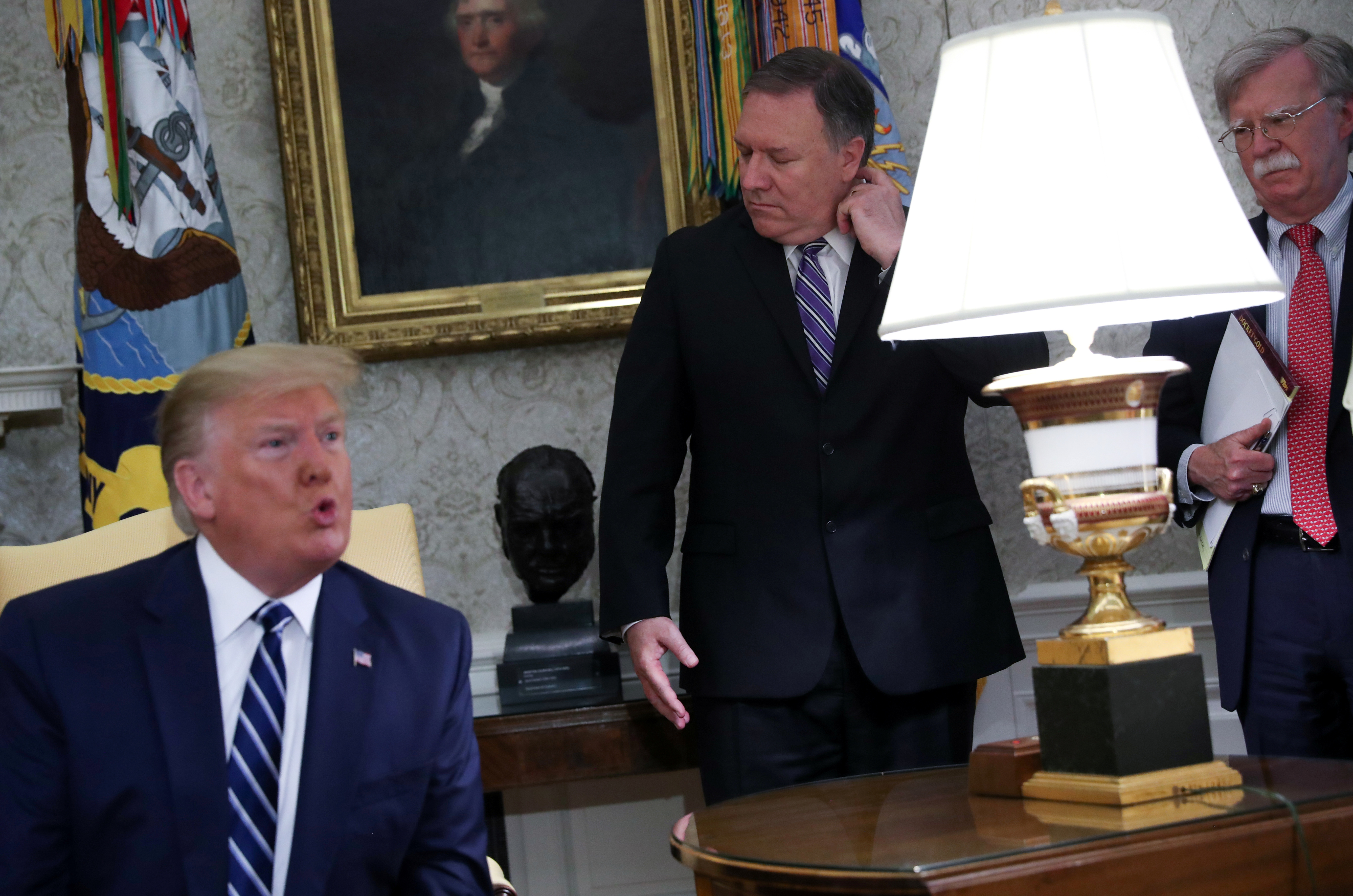 After Iran shot down a U.S. drone, President Trump speculated that &quot;it could have been someone loose and stupid&quot; behind the surface-to-air missile strike. The president spoke about the issue on Thursday as Secretary of State Mike Pompeo (center) and White House national security adviser John Bolton looked on in the Oval Office. (Reuters)