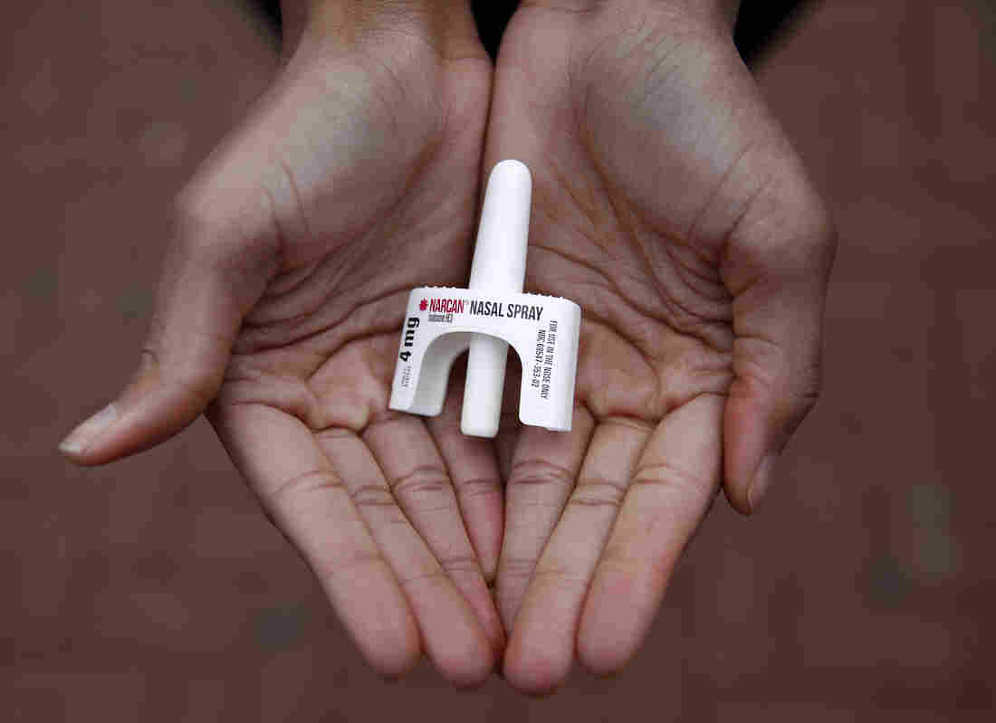 In this Jan. 23, 2018 photo, Leah Hill, a behavioral health fellow with the Baltimore City Health Department, displays a sample of Narcan nasal spray in Baltimore. Public health officials say the drug is a critical tool in addressing America's opioid epidemic. (AP Photo/Patrick Sema