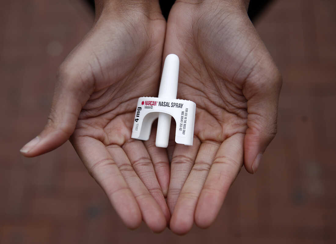 In this Jan. 23, 2018 photo, Leah Hill, a behavioral health fellow with the Baltimore City Health Department, displays a sample of Narcan nasal spray in Baltimore. Public health officials say the drug is a critical tool in addressing America's opioid epidemic. (AP Photo/Patrick Sema