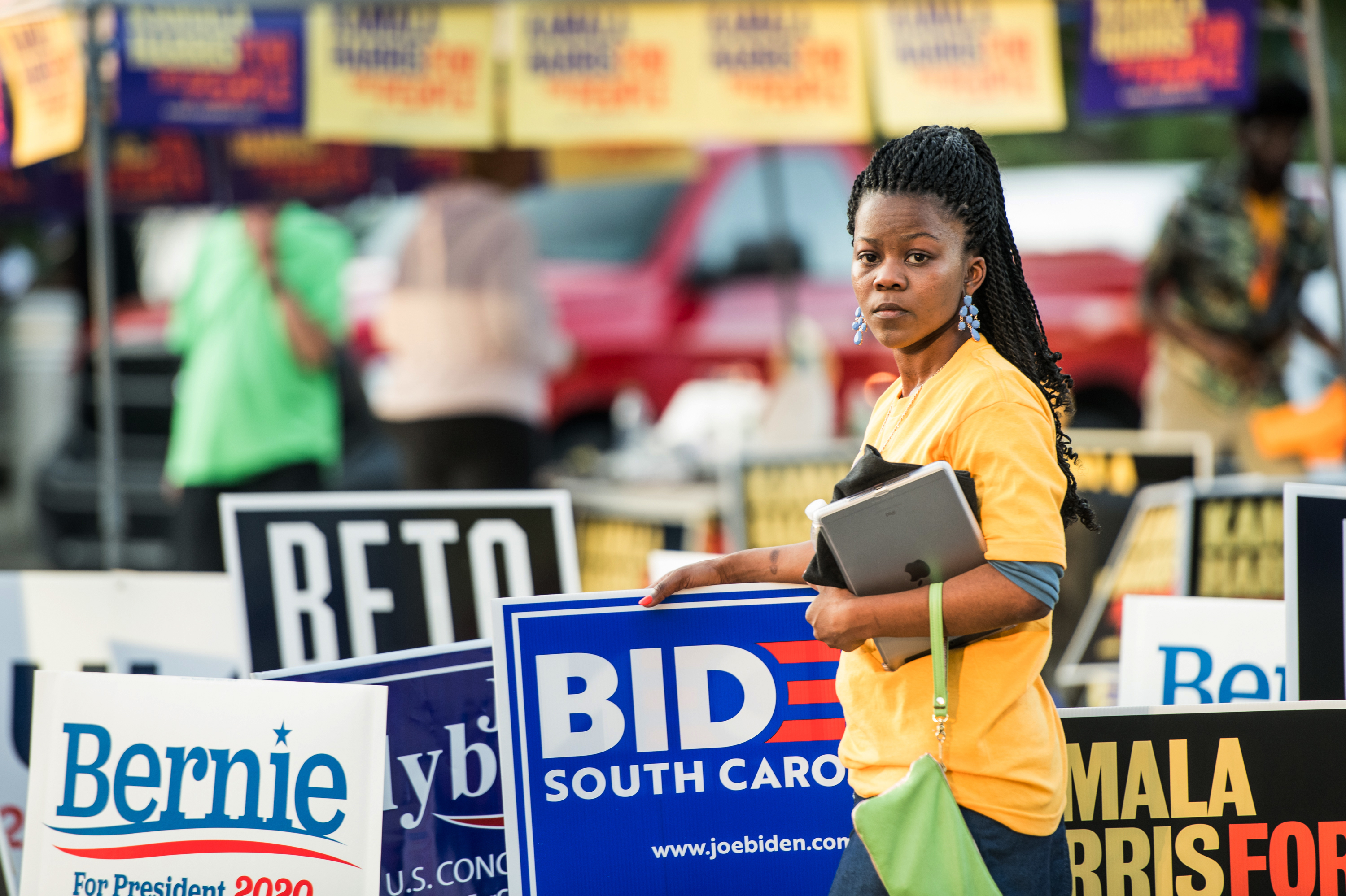 Kanesha Adams stands in the parking lot outside of Jim Clyburn's World-Famous Fish Fry on June 21 in Columbia, S.C. The event featured appearances by 21 Democratic presidential candidates seeking voters in the early primary state. (Sean Rayford for NPR)