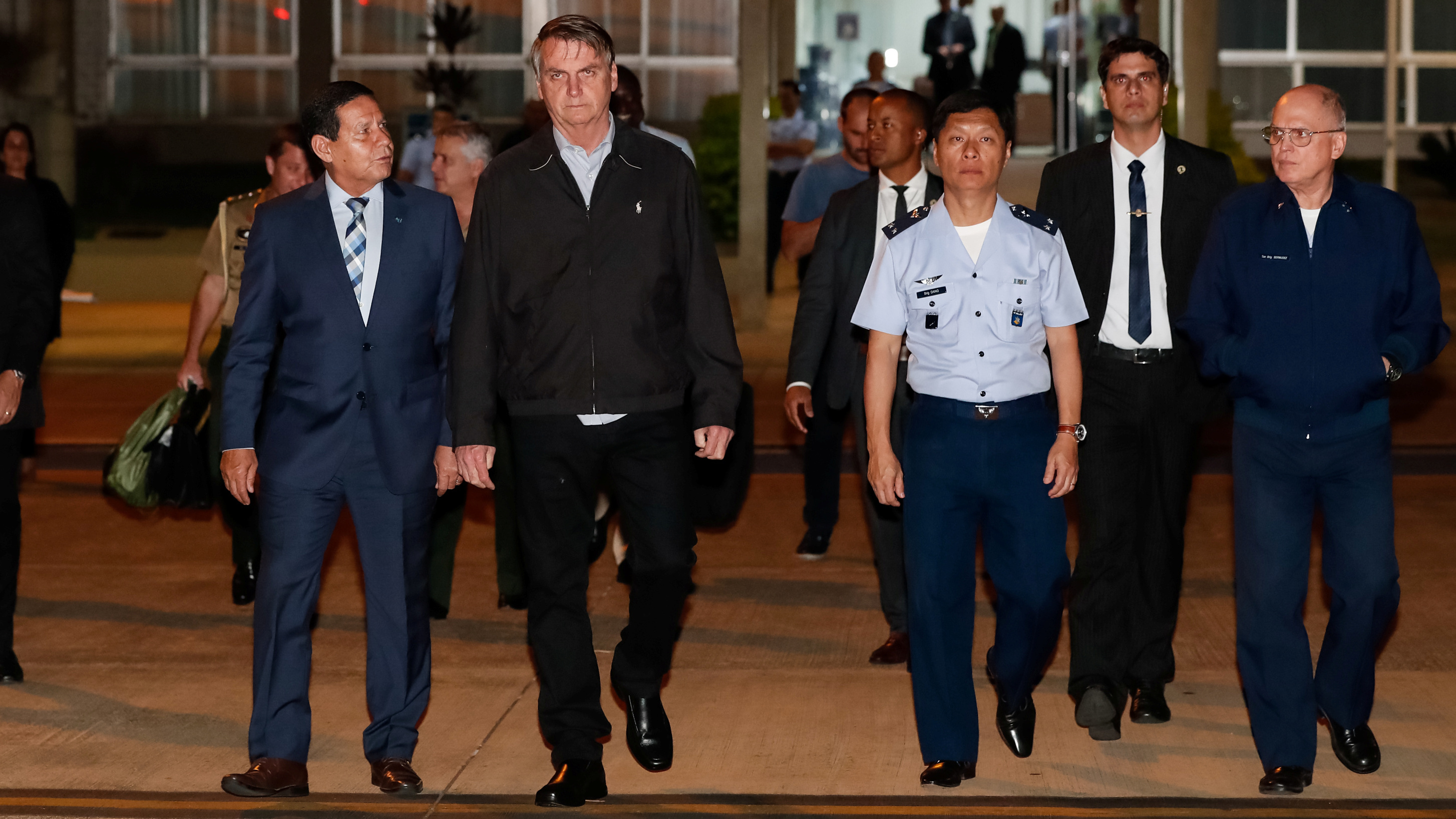 Brazilian President Jair Bolsonaro is calling for severe punishment after 86 pounds of cocaine were found in the luggage of an advance plane for his trip to Japan. Bolsonaro (center) is seen here preparing to leave for this week's G-20 meeting in Osaka.