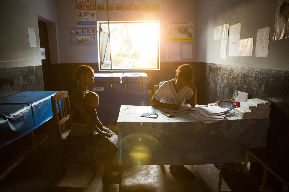 A 19-year-old woman talks with nurse Valeria Zafisoa at a traveling contraception clinic in eastern Madagascar run by the British nonprofit group Marie Stopes International. (Samantha Reinders for NPR)