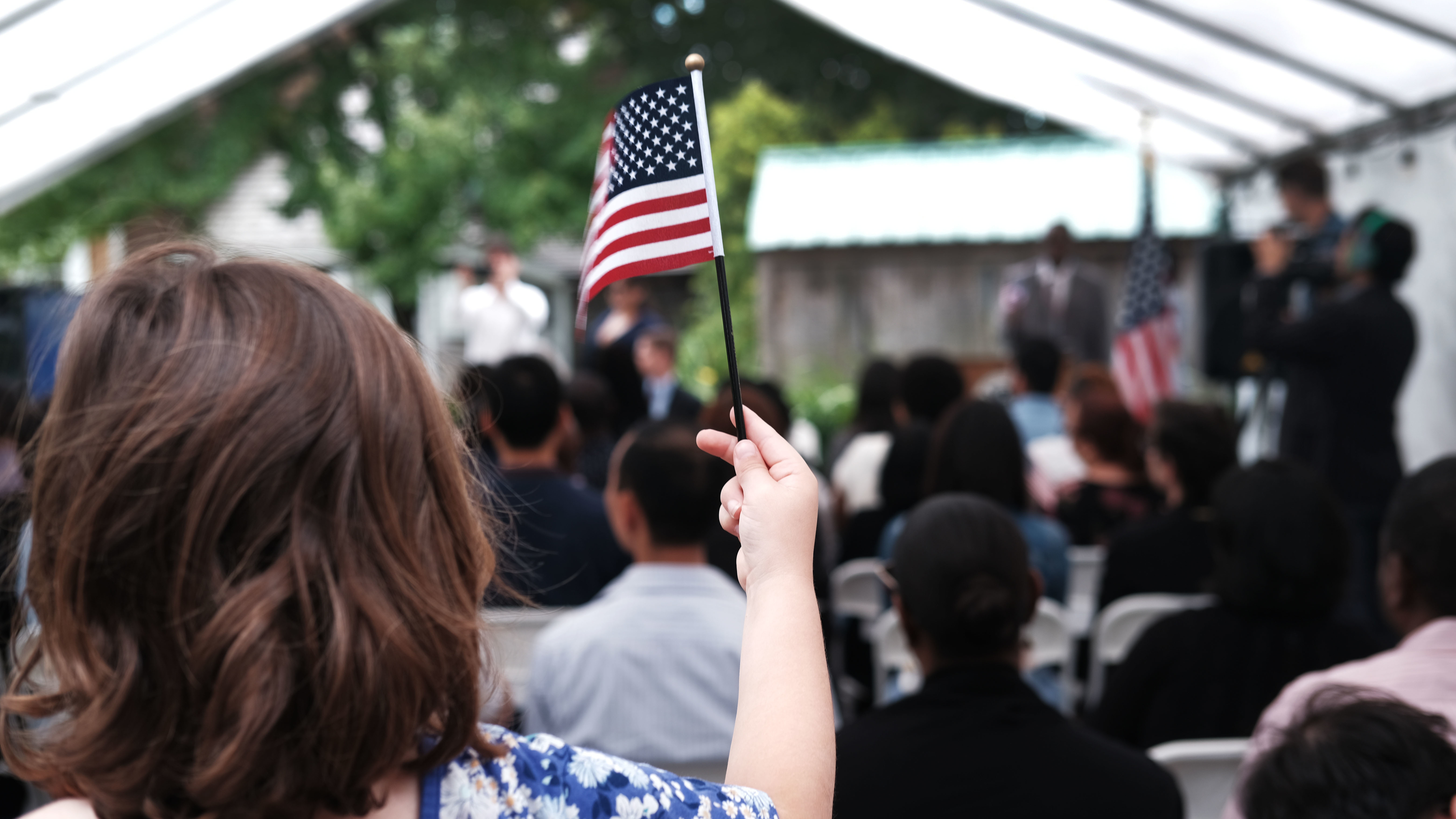 A child holds a U.S. flag at a naturalization ceremony at the Wyckoff House Museum in Brooklyn, on June 14, in New York City.