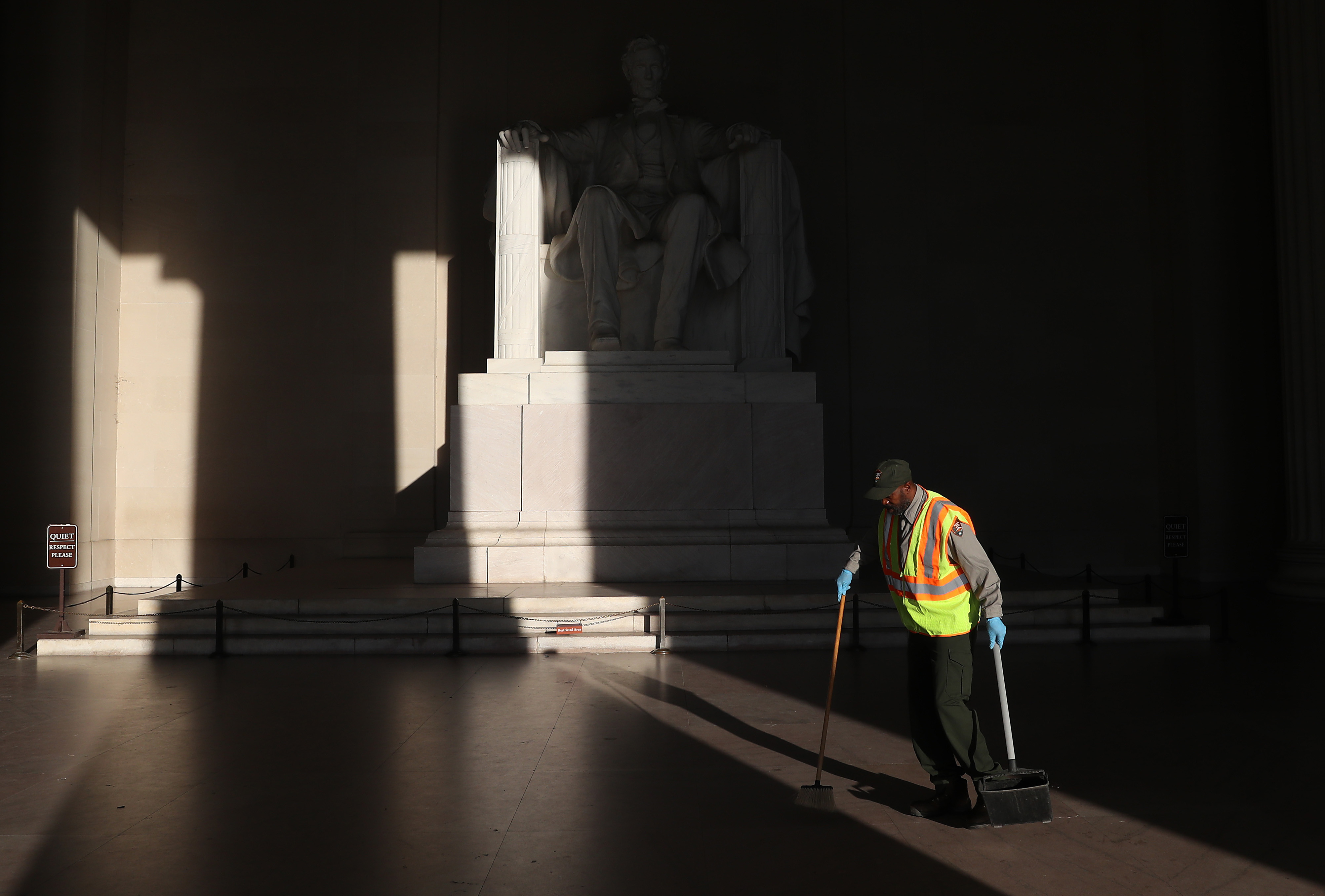 National Park Service worker Corey Felder picks up trash inside the Lincoln Memorial on Tuesday ahead of Thursday's July 4 celebration.