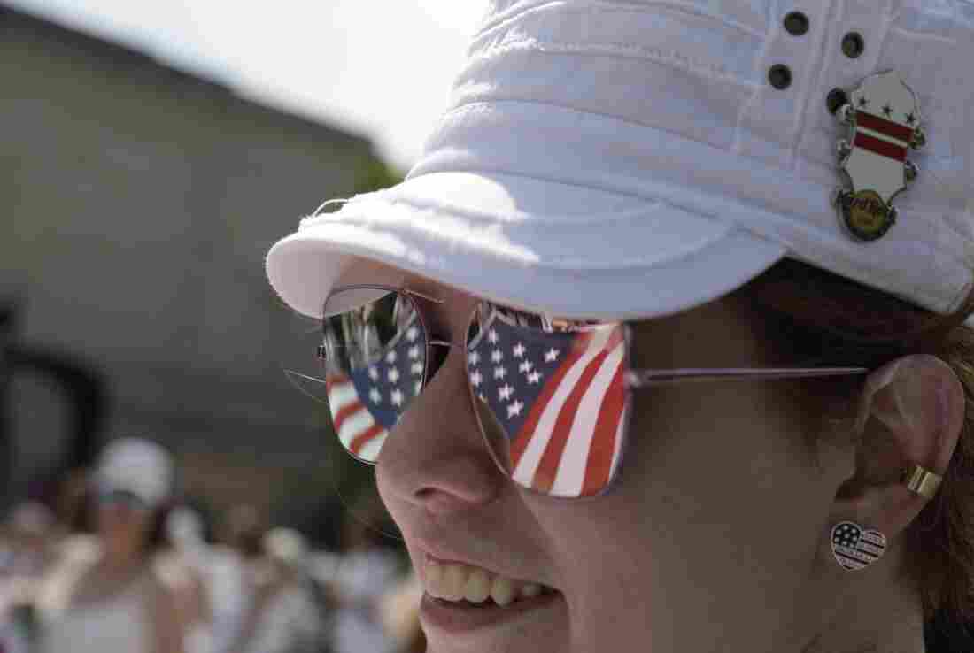 Stars and stripes are reflected in an onlooker's sunglasses during the National Independence Day Parade in Washington, D.C.