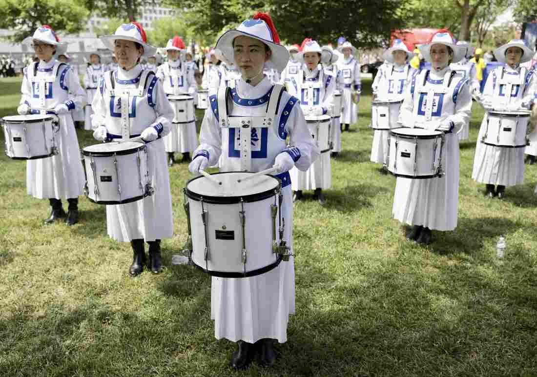 Drummers stand in formation on the grass as part of the National Independence Day Parade festivities in Washington, D.C.