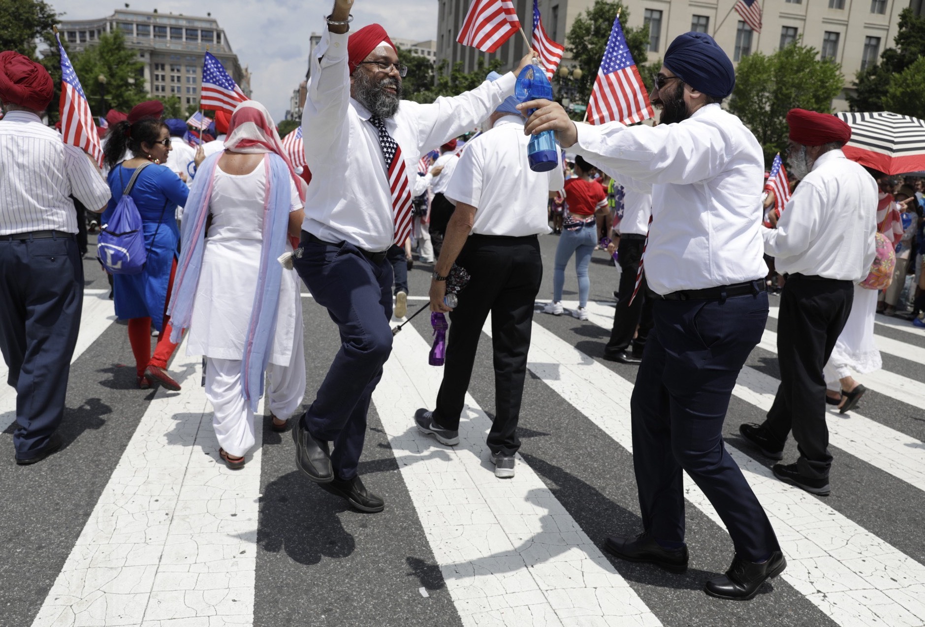 Members of the Sikhs of America dance as they take part in the National Independence Day Parade in Washington, D.C. (WAMU)