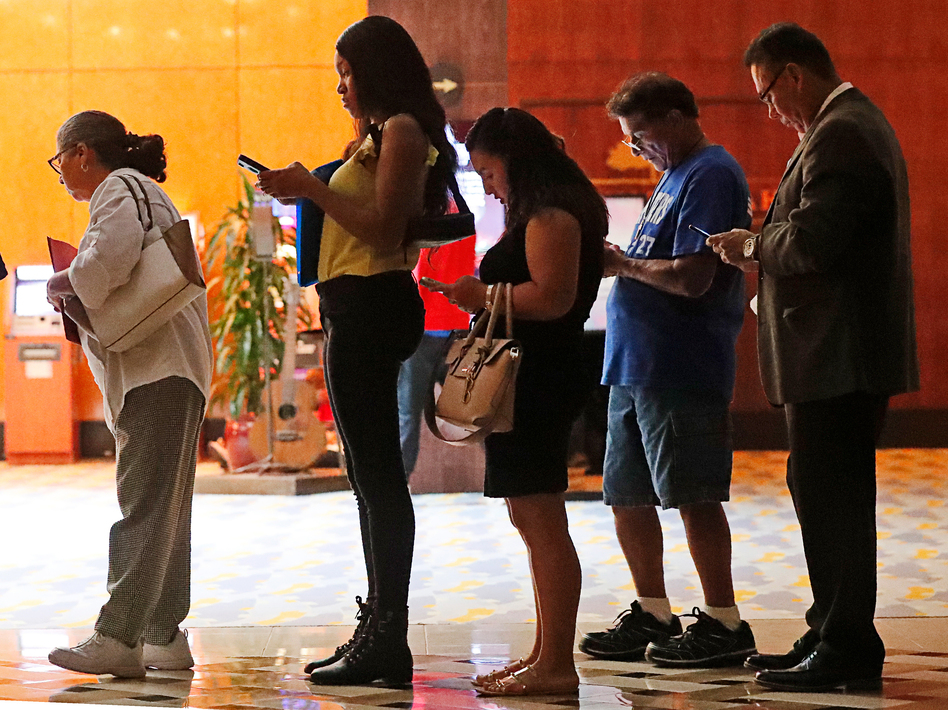 Job applicants wait in line at the Seminole Hard Rock Hotel & Casino Hollywood during a job fair in Hollywood, Fla., on Thursday. (Wilfredo Lee/AP)