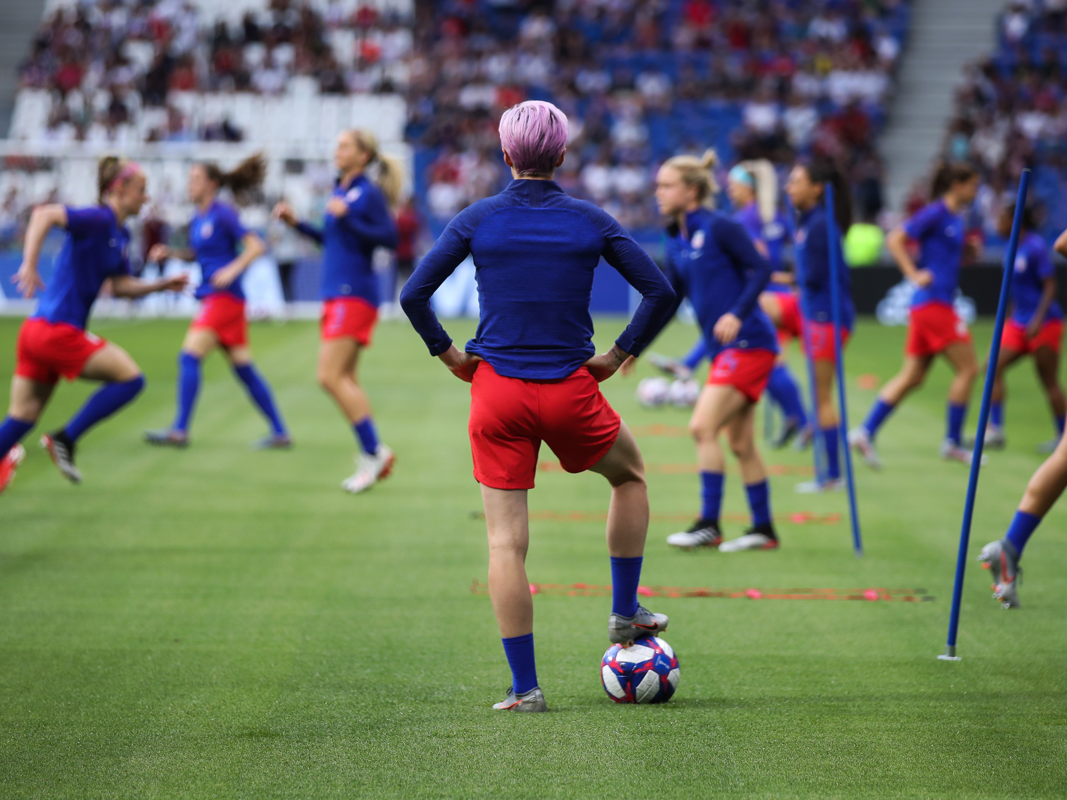 The Netherlands are the last team standing between the United States and its fourth Women's World Cup. Here, U.S. forward Megan Rapinoe watches her teammates warm up before Tuesday's 2-1 semifinal win over England. (Getty Images)
