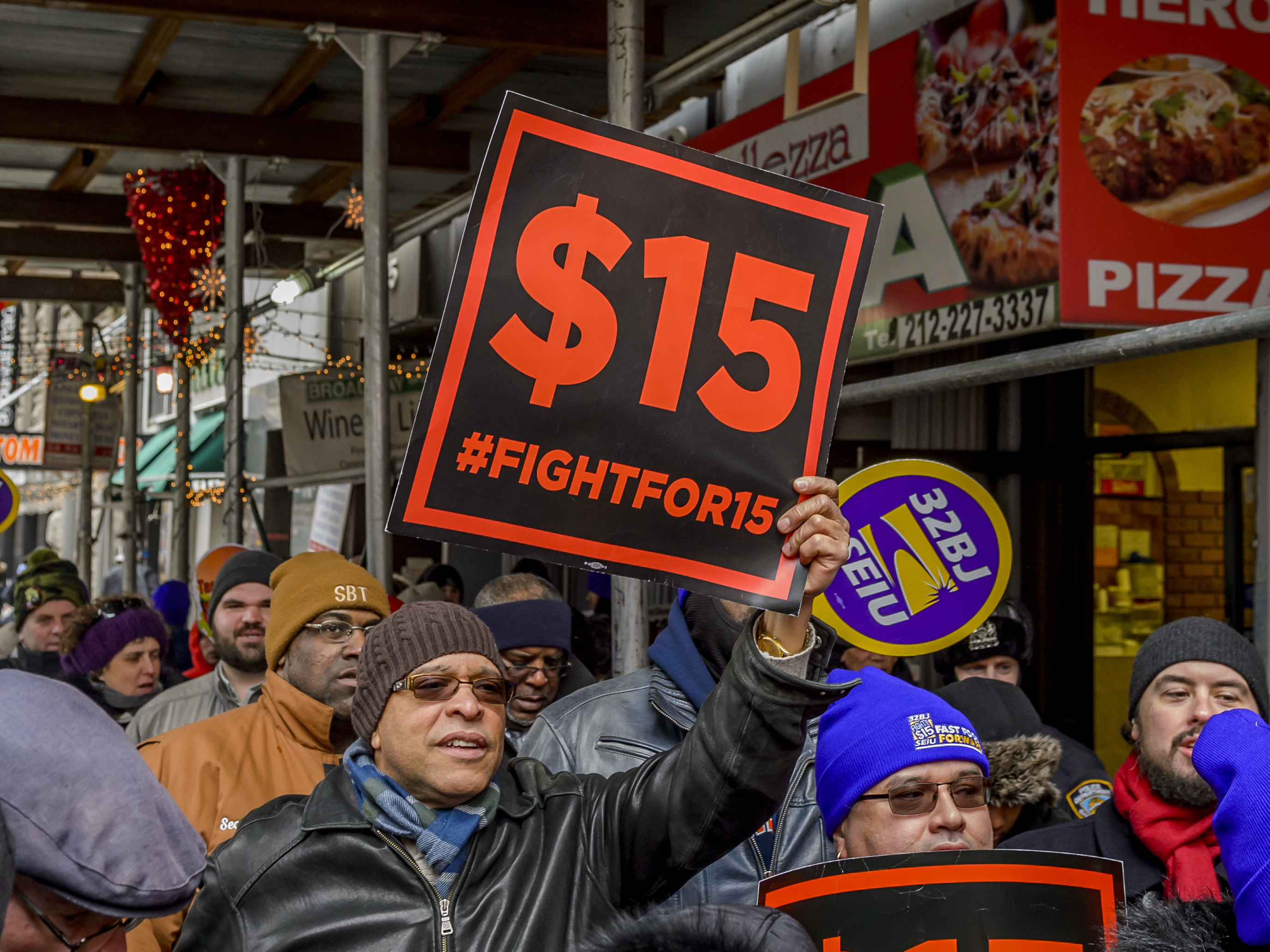 People protest for a $15 minimum wage in New York City in 2017. (LightRocket via Getty Images)