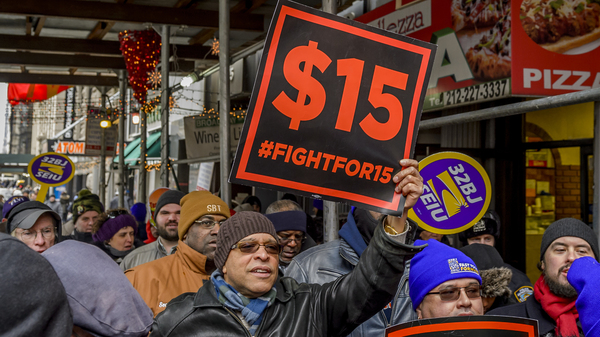 People protest for a $15 minimum wage in New York City in 2017.