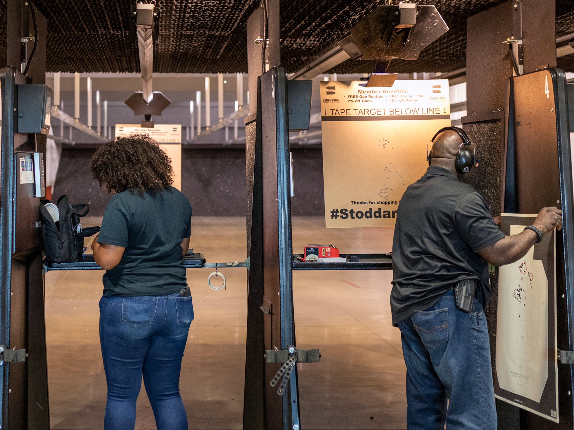 Michael Doyle (left), Casandra Light and Colin Mapp prepare to shoot and review their targets in a gun range in Atlanta.