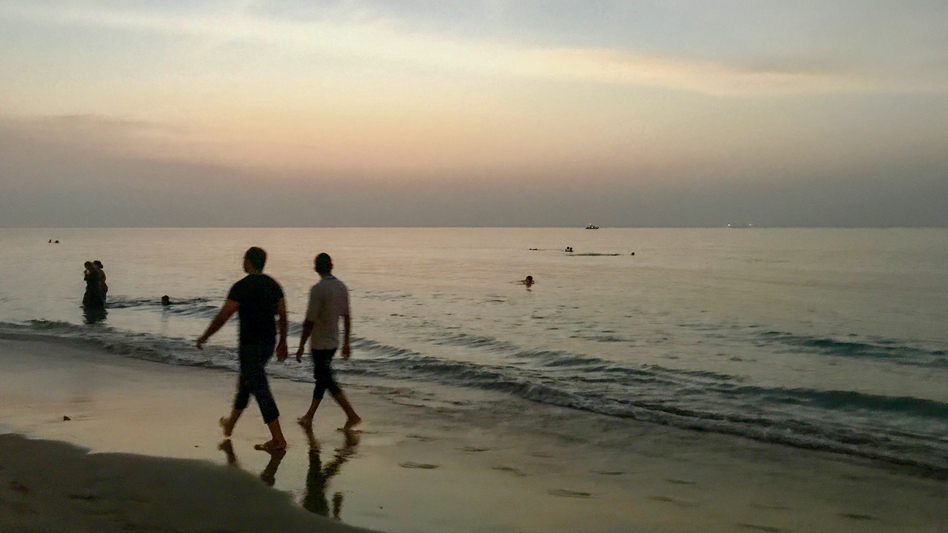 Omanis enjoy a respite from the scalding summer heat by swimming and relaxing on the beach in Muscat.