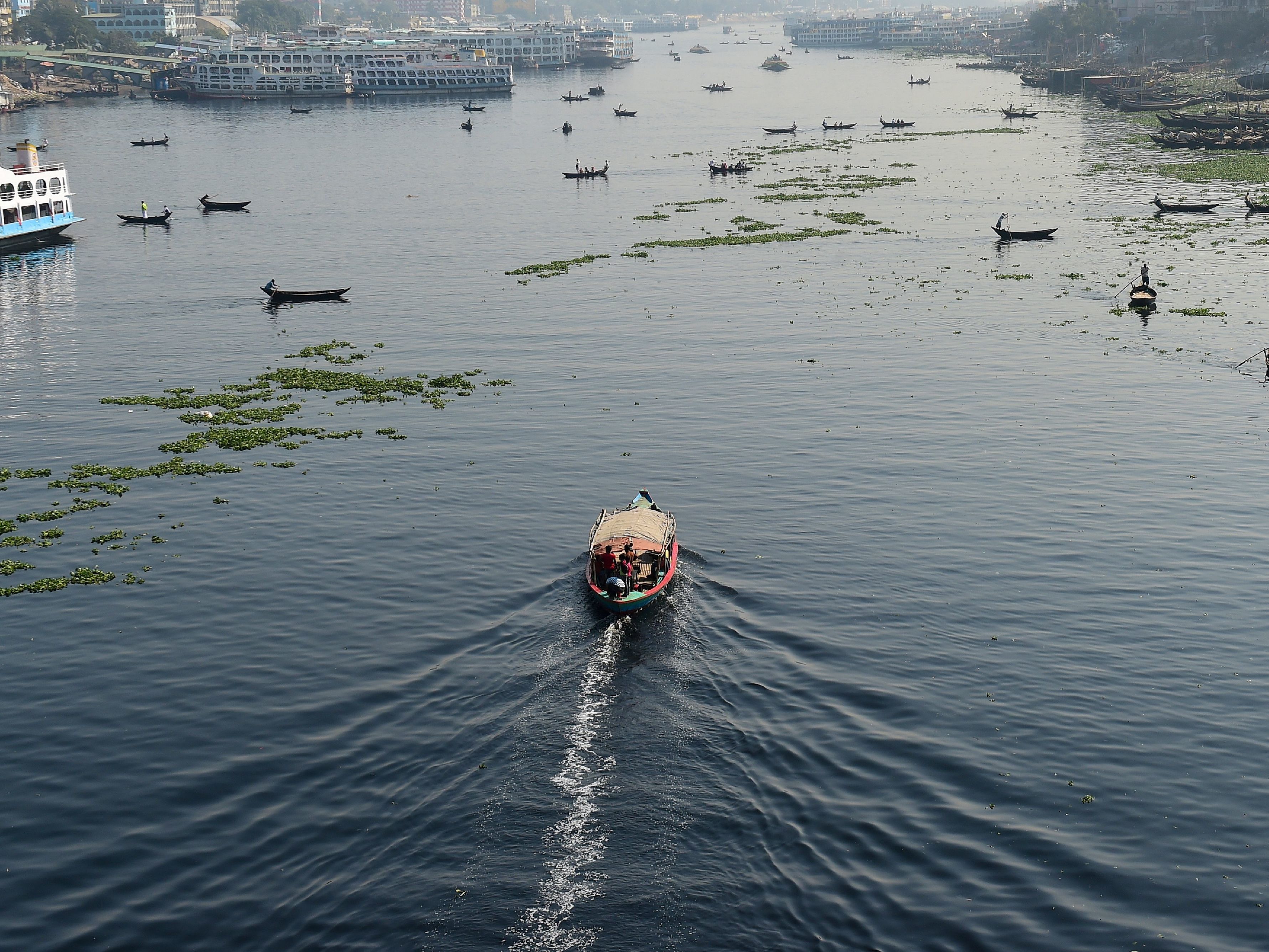 Bangladeshi commuters use boats to cross the Buriganga River in the capital Dhaka in 2018. In July, Bangladesh's top court granted all the country's rivers the same legal rights as humans. (AFP/Getty Images)