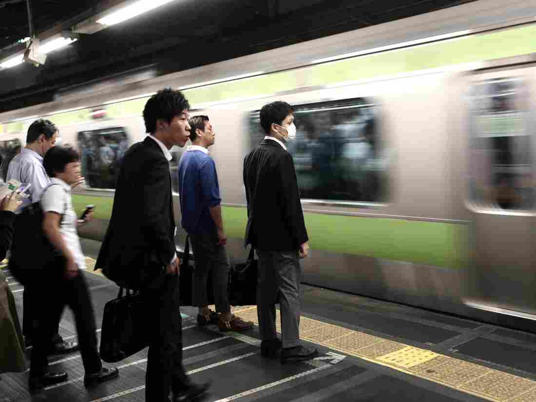 In this picture taken on October 12, 2017, people wait for the train at a subway station in Tokyo.