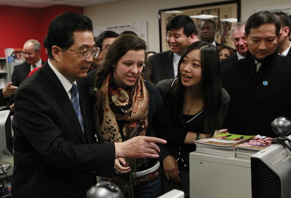 In this 2011 photo, Hu Jintao, then China's president, visits the Confucius Institute at the Walter Payton College Preparatory High School in Chicago. China established more than 100 Confucius Institutes, which provide language and culture programs, at U.S. schools. But at least 13 universities have dropped the program due to a law that raises concerns about Chinese spying. (Chris Walker/AP)