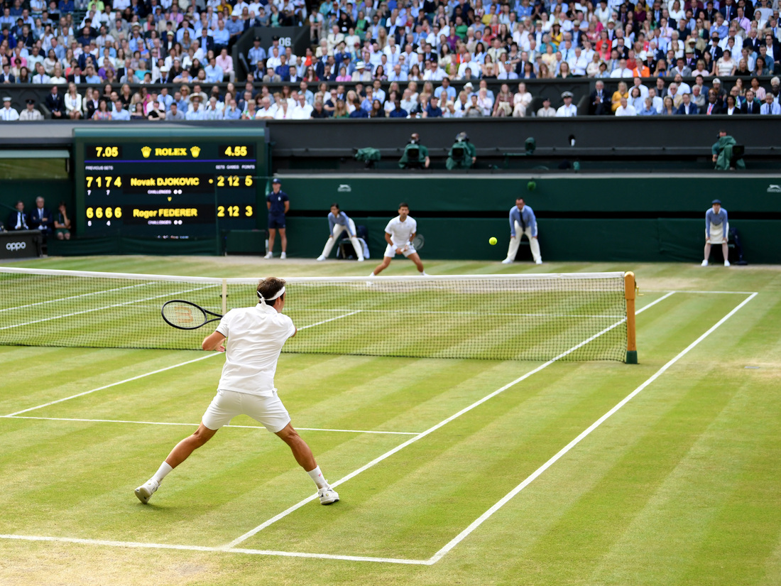 Roger Federer of Switzerland plays a forehand against Novak Djokovic of Serbia during the 2019 Wimbledon men's final on July 14 in London.