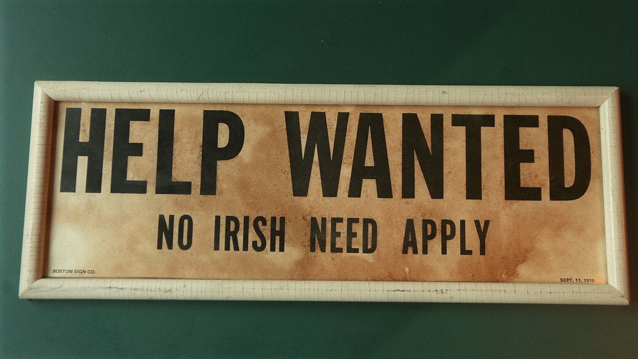 A now-closed Irish pub in Lawrence, Mass., displayed an old &quot;Help Wanted/No Irish Need Apply&quot; — a common sight across the country in the mid-1800s. (Boston Globe via Getty Images)