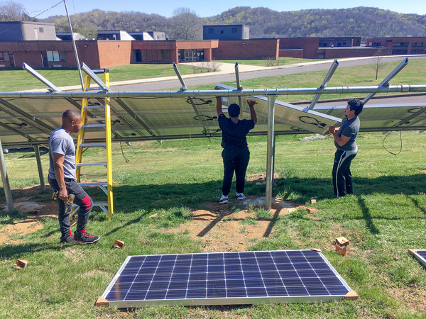 Whites Creek High School seniors Daniel Van Clief (left) and Kelando Rogan (center) are joined by Michael MacMiller, a regional organizer for the Southern Alliance for Clean Energy. All three consider Carney a mentor.