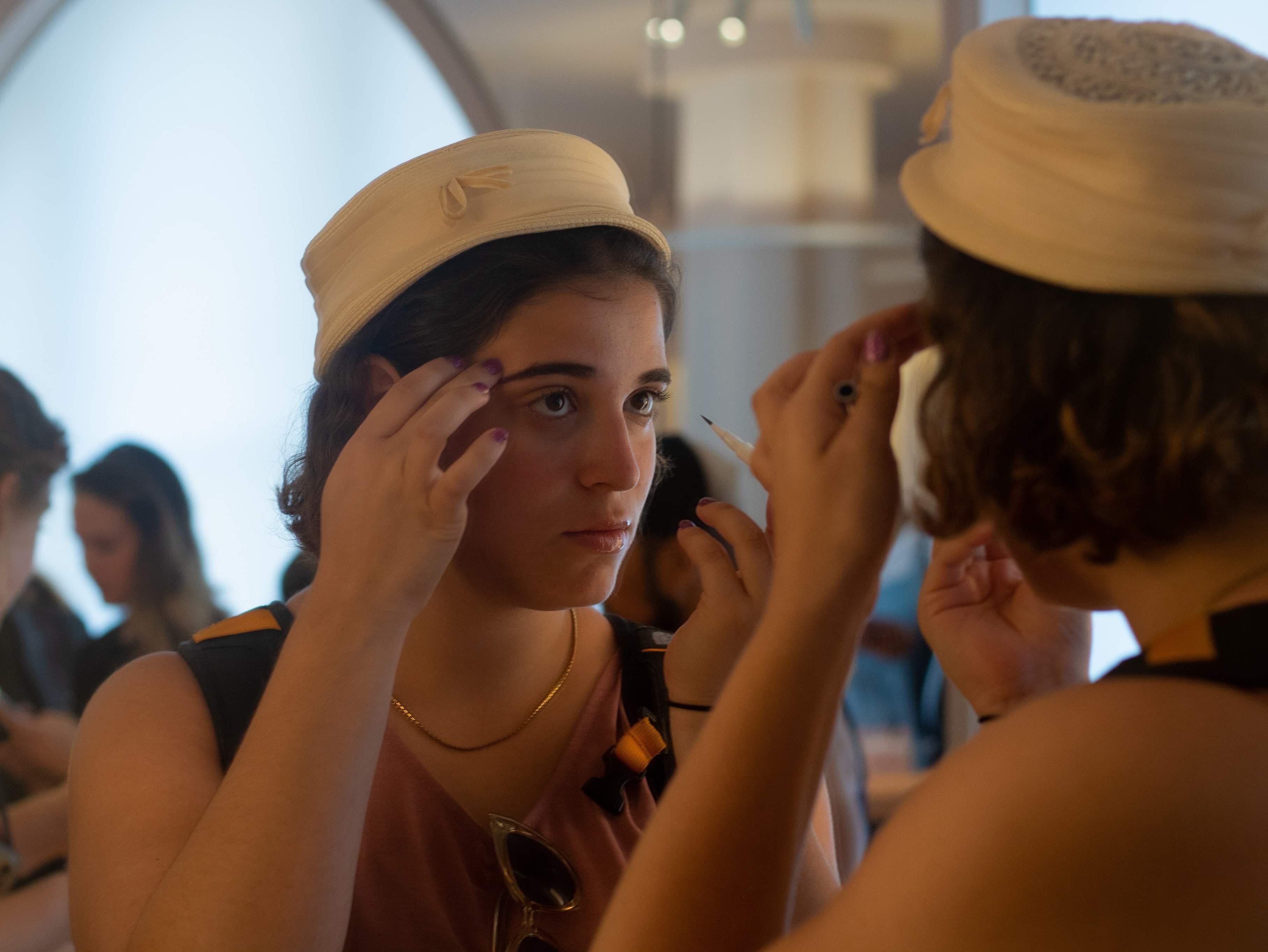 A customer tests an eyebrow pencil in the mirror at the New York City flagship store for the beauty startup Glossier. It's one of the latest companies to become a unicorn, with a market value of $1 billion as of March. (NPR)