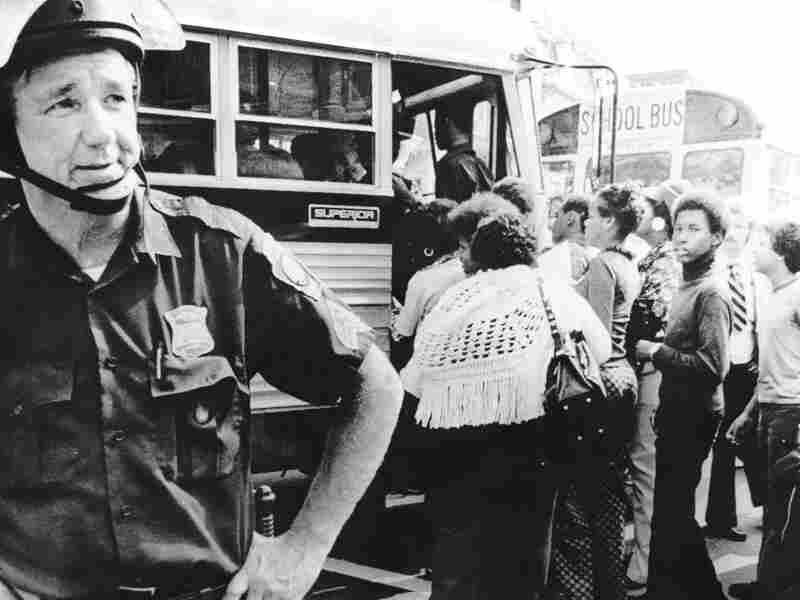 A police on guard as Boston begins a school busing program on September 12, 1974, to integrate Boston Public Schools under a court order.