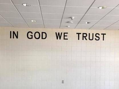An "In God We Trust" sign is seen at a middle school in Rapid City, South Dakota. Staff began installing the national motto in the district's 23 schools in May.