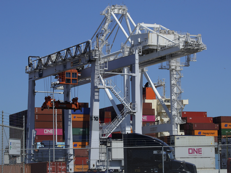 A container ship is unloaded at the Port of Oakland in California. A drop in exports contributed to a slowdown in U.S. economic growth in the second quarter. (Ben Margot/AP)