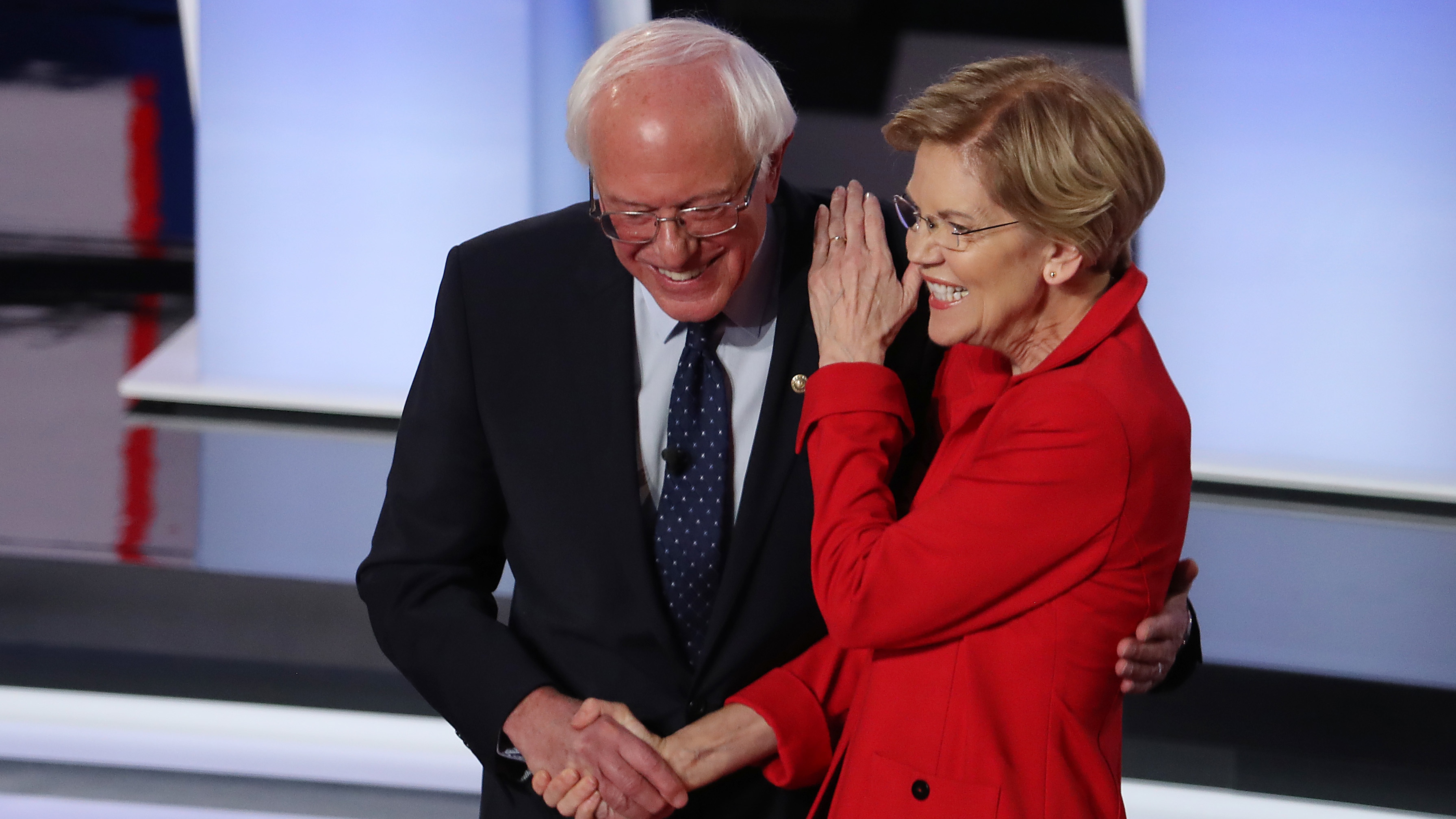 Democratic presidential candidates Sens. Bernie Sanders and Elizabeth Warren greet each other at the start of Tuesday night