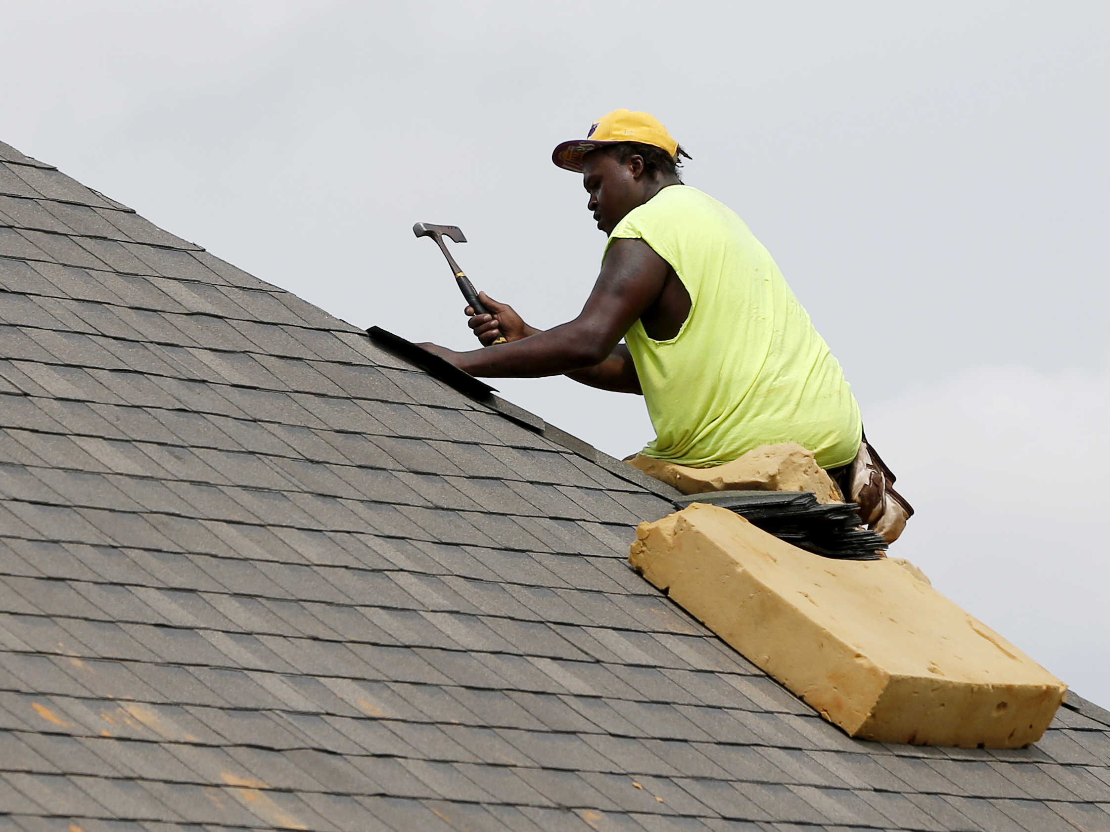 A construction worker lays down shingles on the roof of a new house in Brandon, Miss., on June 19. Construction jobs rose 4,000 in July â below the 18,000 added in June and the 19,000 added in July 2018.