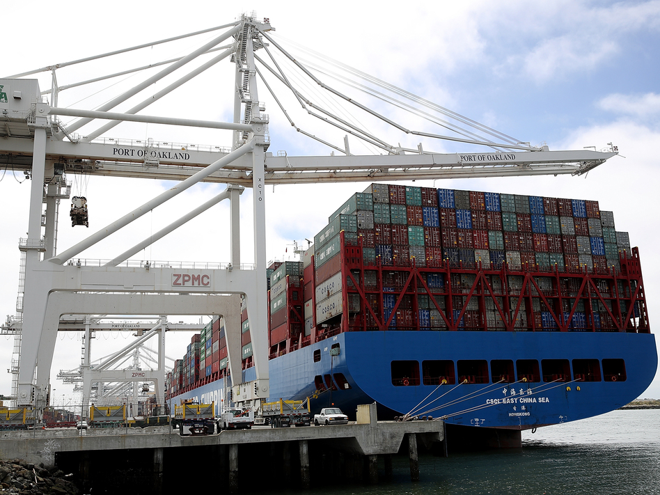 A container ship sits in a berth at the Port of Oakland in California last year. President Trump announced additional tariffs on imports from China on Thursday. (Justin Sullivan/Getty Images)