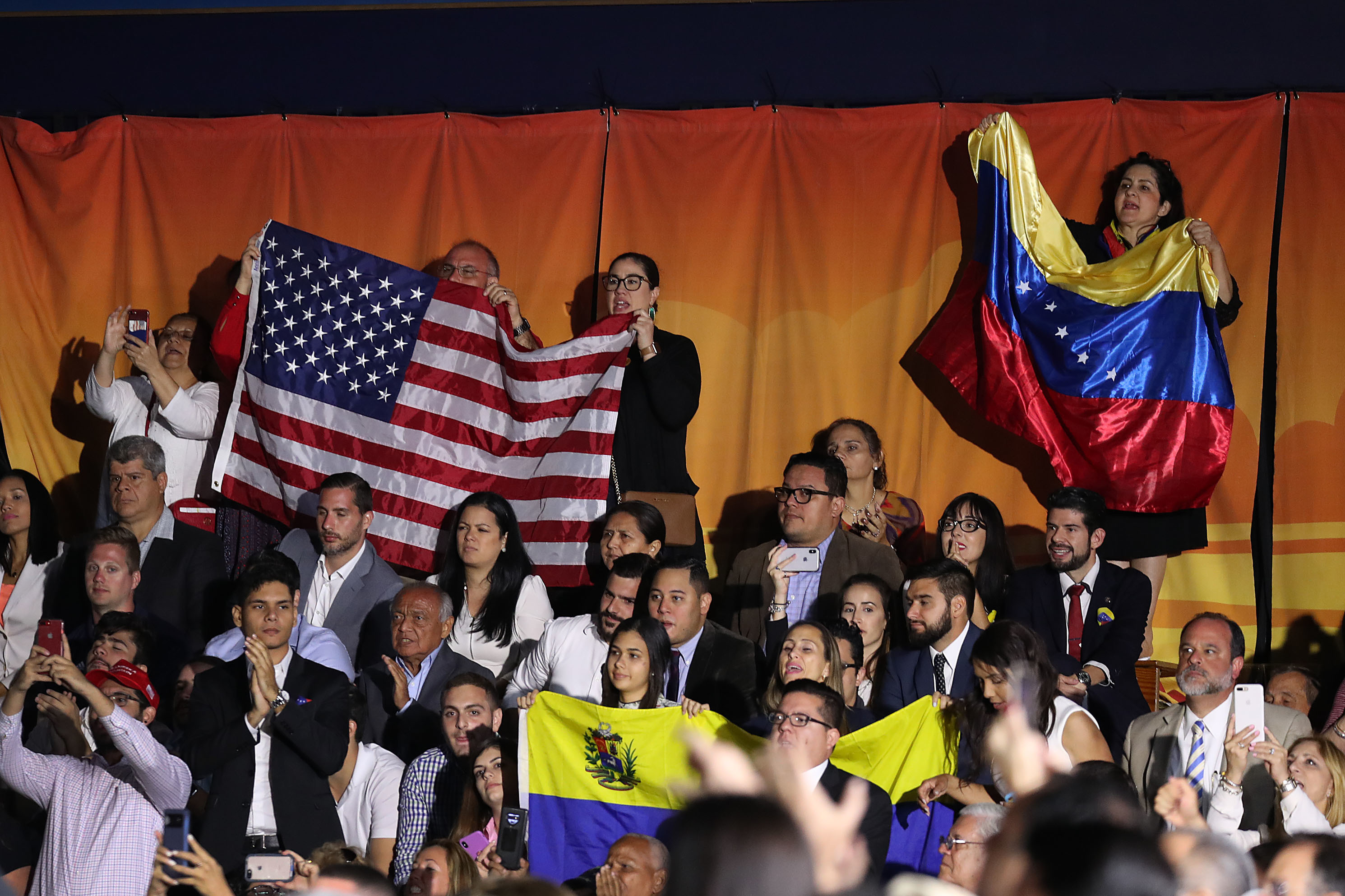 People listen as President Trump speaks during a rally at Florida International University on Feb. 18, 2019 in Miami where he addressed the crisis in Venezuela. Trump's administration is considering a protected status for Venezuelans living in the U.S.