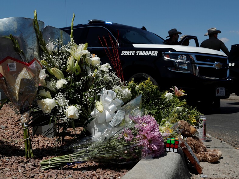 Flowers adorn a makeshift memorial near the scene of a mass shooting at a shopping complex Sunday in El Paso, Texas. (John Locher/AP)
