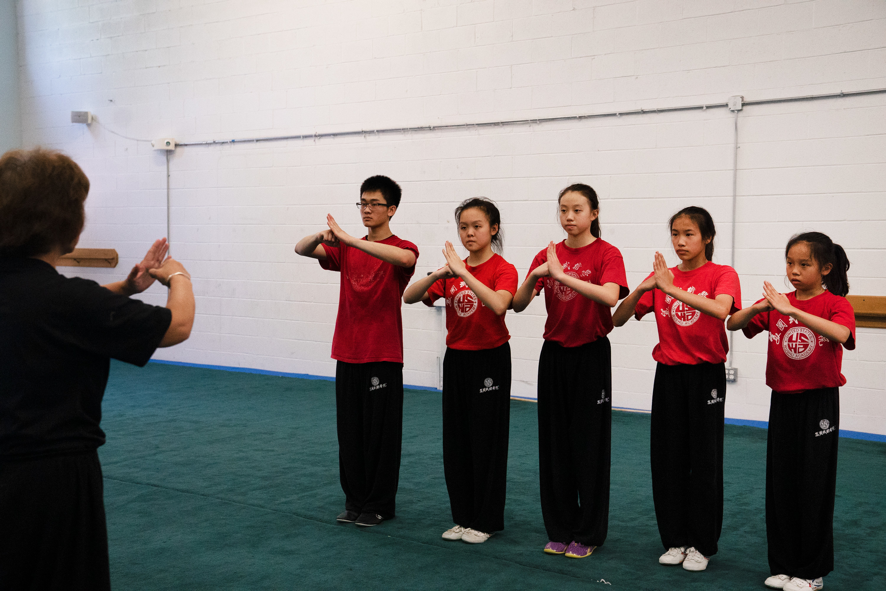 Wushu Coaches Help Chinese Students Master Literacy And 'Become A Better Person' 9 Students greet Zhang before practice. She can be loud and strict, but often call her students Bǎo Bèi Er, or my baby, and her students call her Mā, or mom.