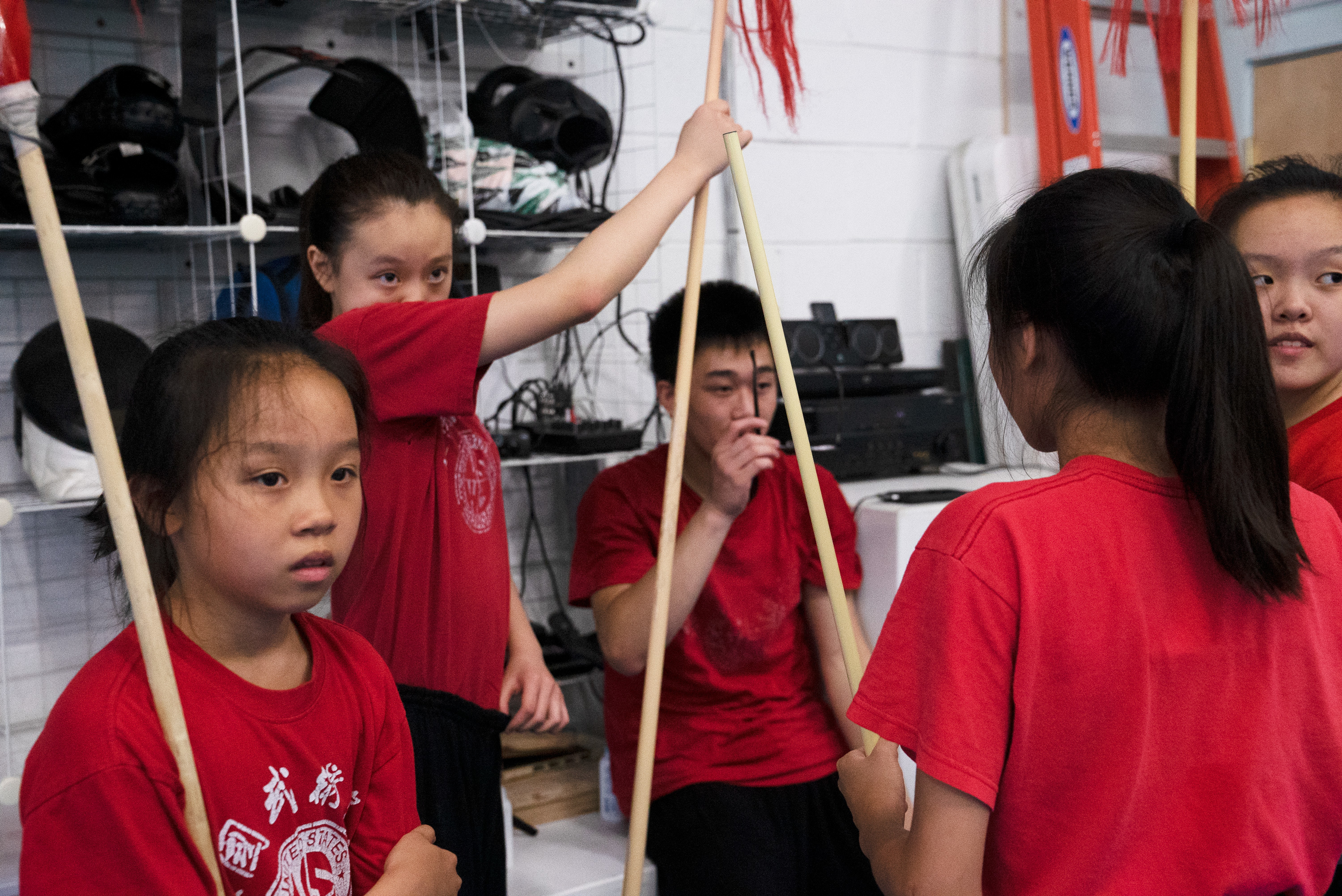 Wushu Coaches Help Chinese Students Master Literacy And 'Become A Better Person' 5 The advanced team, Jocelyn Gu, 12, Michelle Xiong, 14, Benjamin Tran, 15, Joanne Li, 13, Helen Gu, 16, listens to feedback from Zhang.