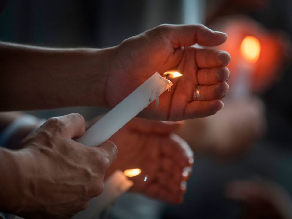 People light candles during a prayer and candle vigil organized by the city, after the recent shooting at a WalMart in El Paso, Texas. (AFP/Getty Images)