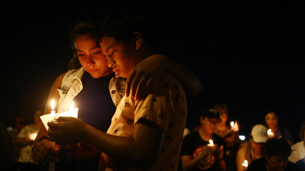 People attend a candlelight prayer vigil outside Immanuel Baptist Church, located near the scene of the mass shooting on August 5, 2019 in El Paso, Texas.