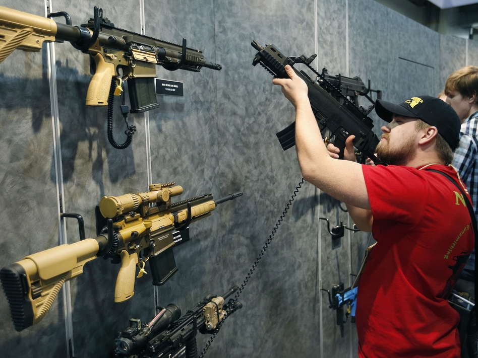 A visitor peruses H&K rifles at the SHOT Show in Las Vegas. Such weapons were once restricted under a 1994 ban that expired with changing politics in the United States.