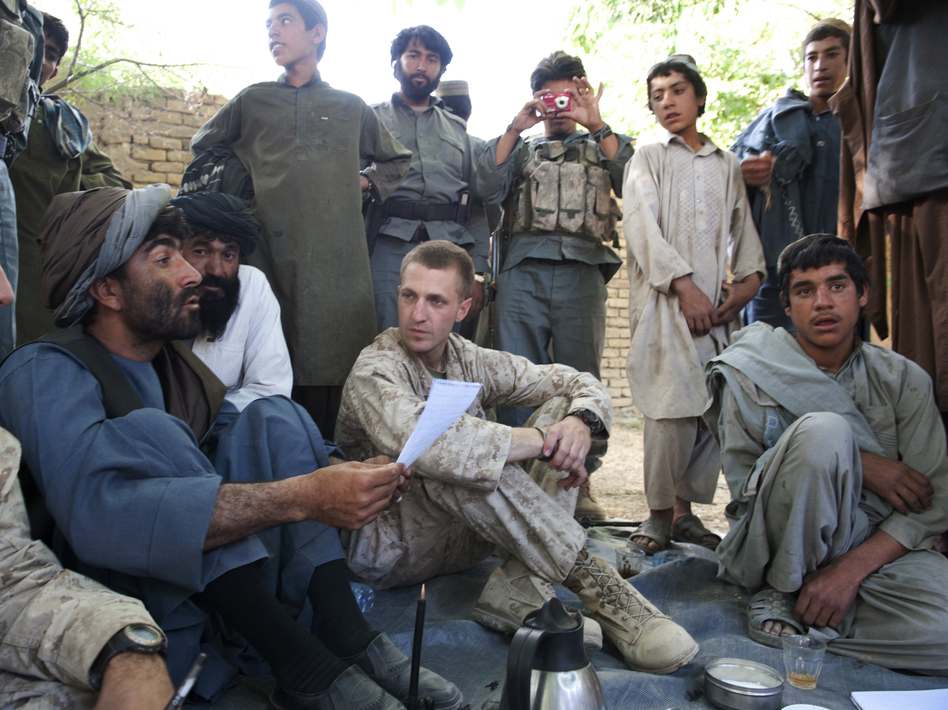 Jason Brezler, seated center, holds a meeting with local governors in Afghanistan in 2010. Brezler faced discharge after emailing classified documents over an insecure network. He challenged the Marine Corps' decision.