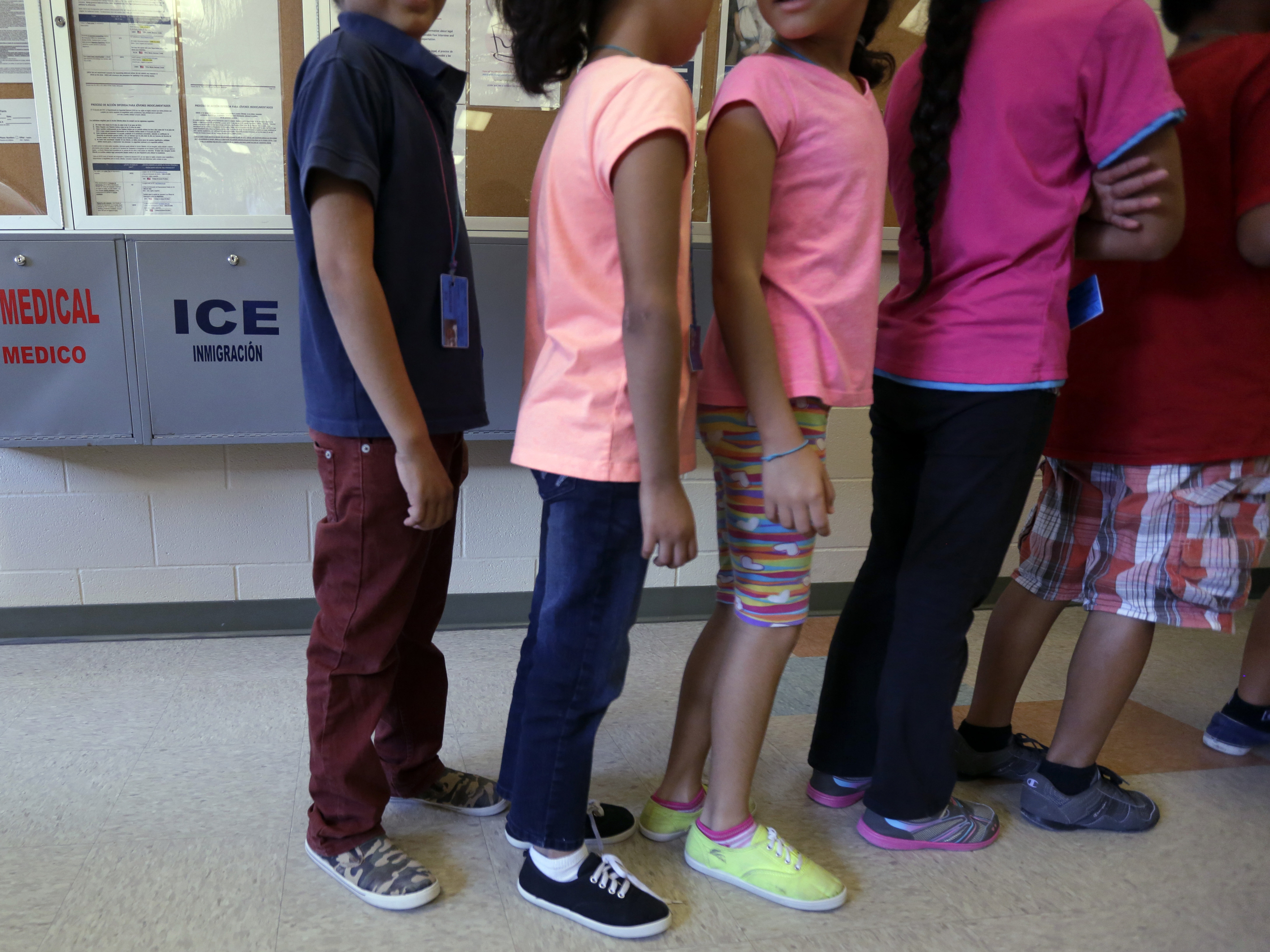 Detained immigrant children line up at a temporary home for immigrant women and children in Karnes City, Texas.