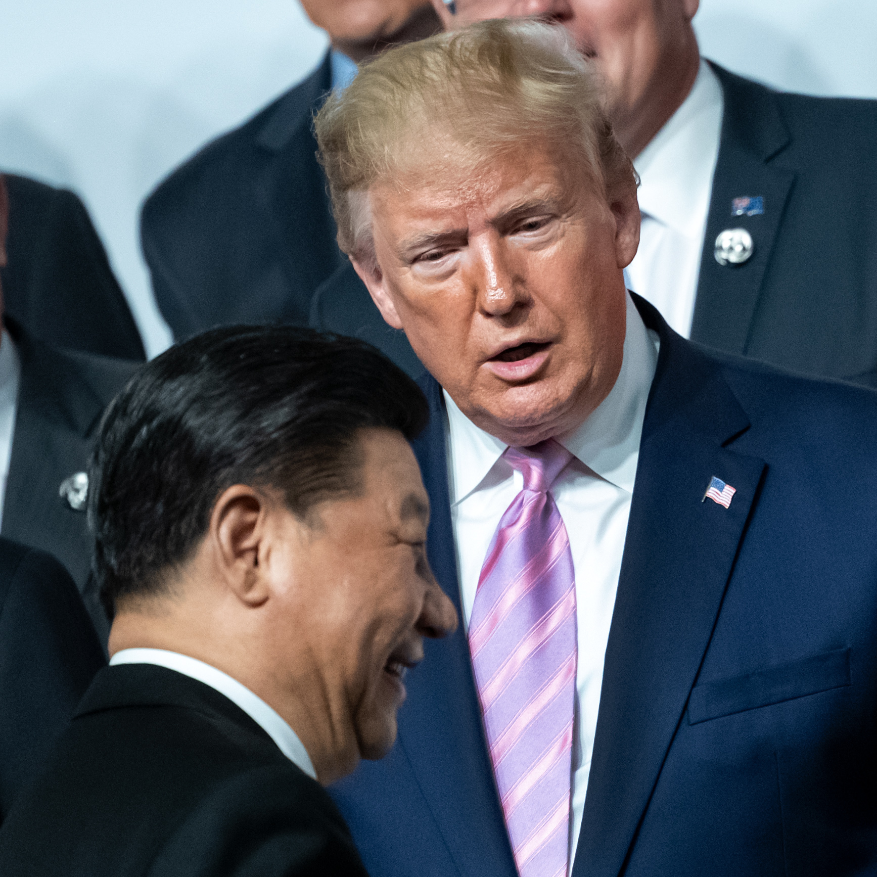 China's President Xi Jinping and President Trump, chat as they pose for the group photo at the beginning of the G20 summit in Osaka, Japan, in June. Trump has offered to meet with Xi about resolving protests in Hong Kong.